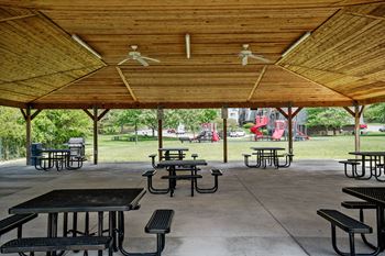 A covered picnic area with tables and chairs.